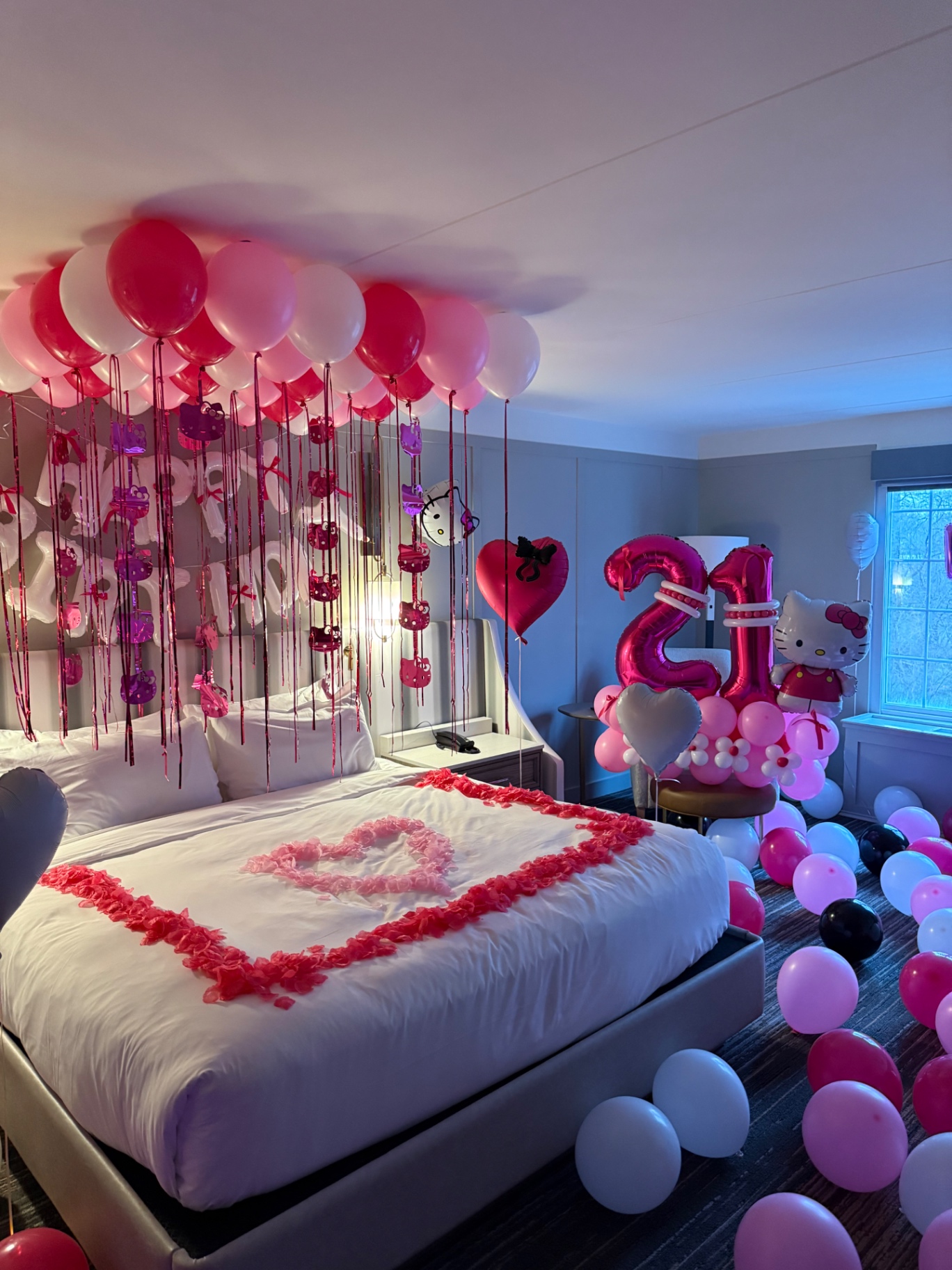 Hello Kitty 21st birthday hotel suite with pink balloon ceiling