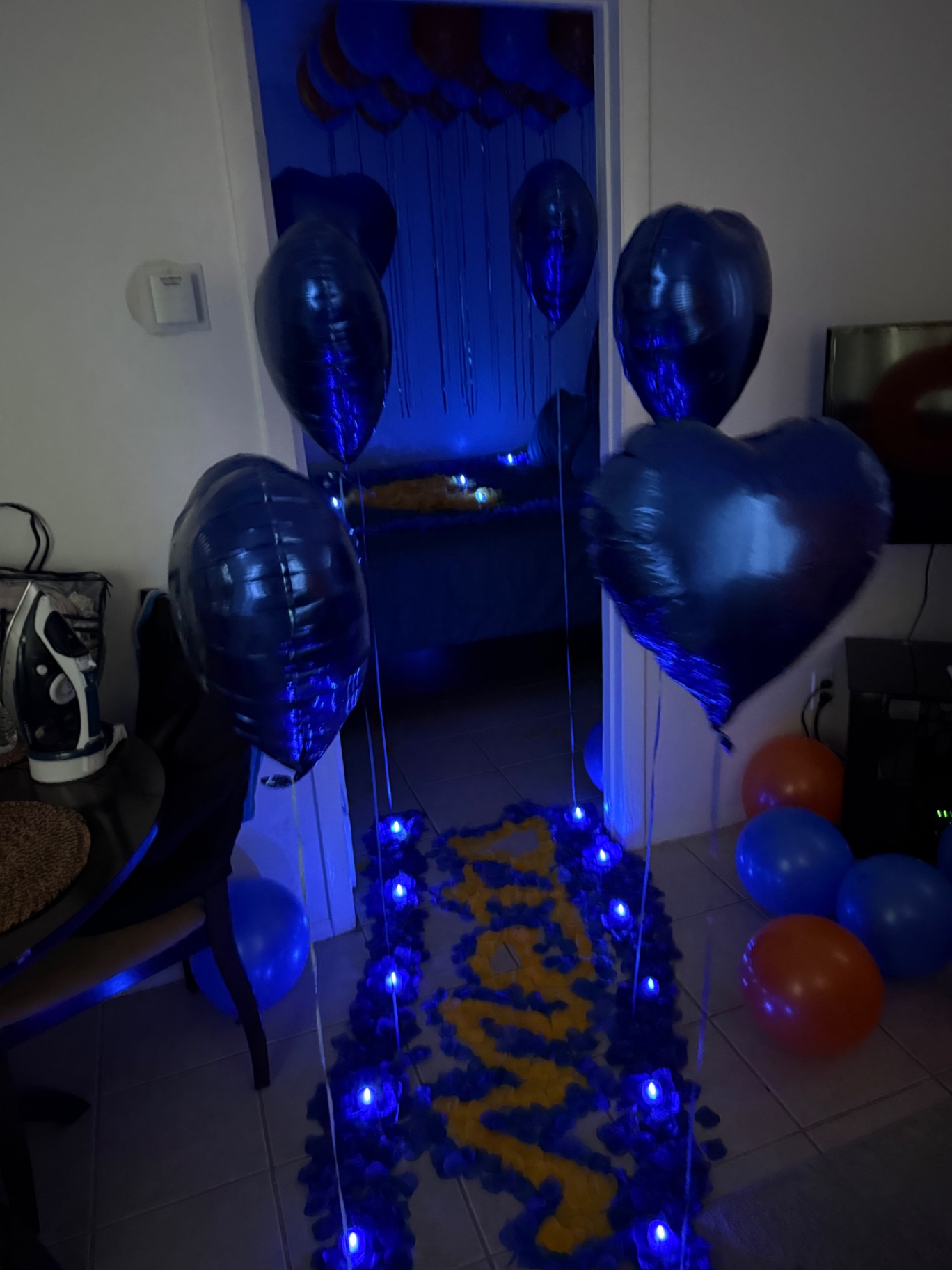 Blue heart balloon bouquets with rose petal name pathway