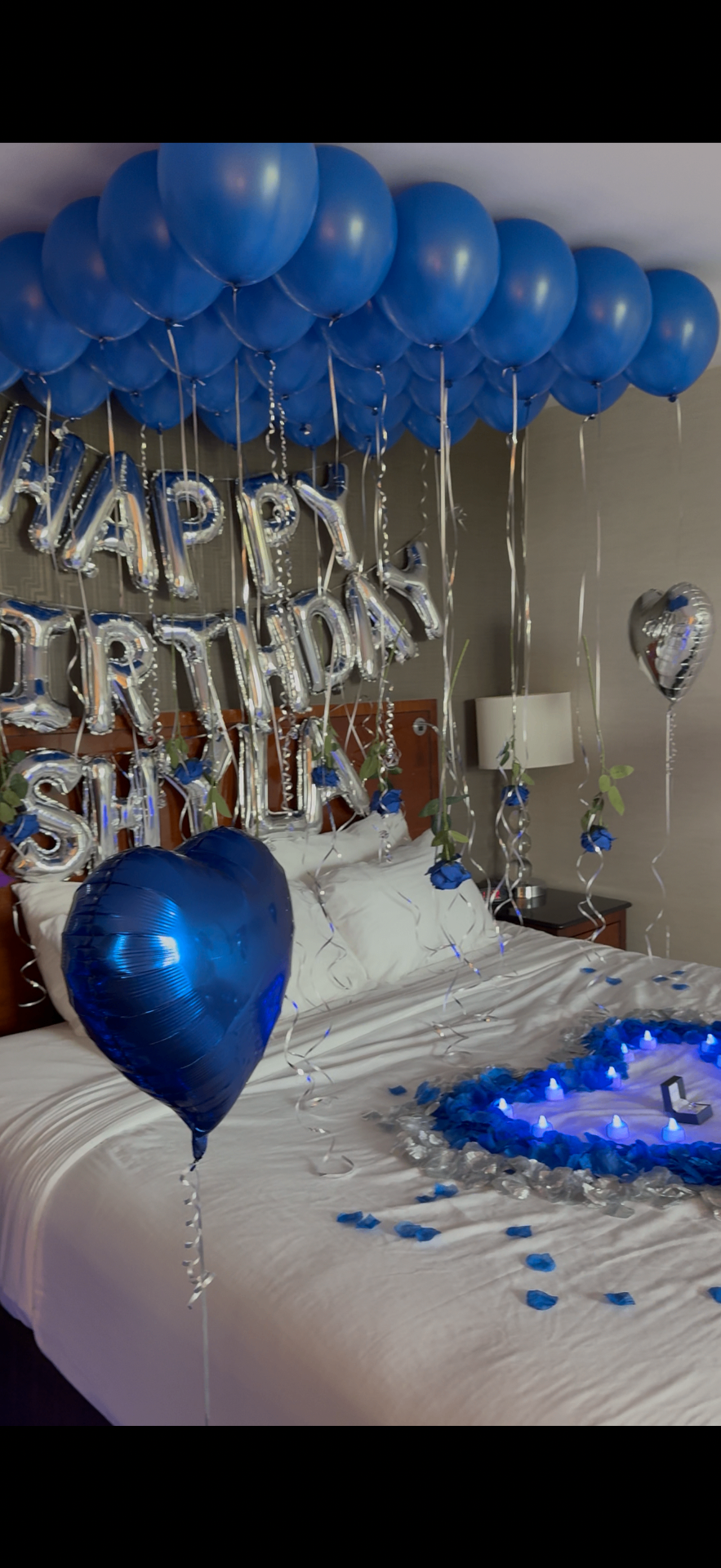 Royal blue and silver Happy Birthday hotel suite setup