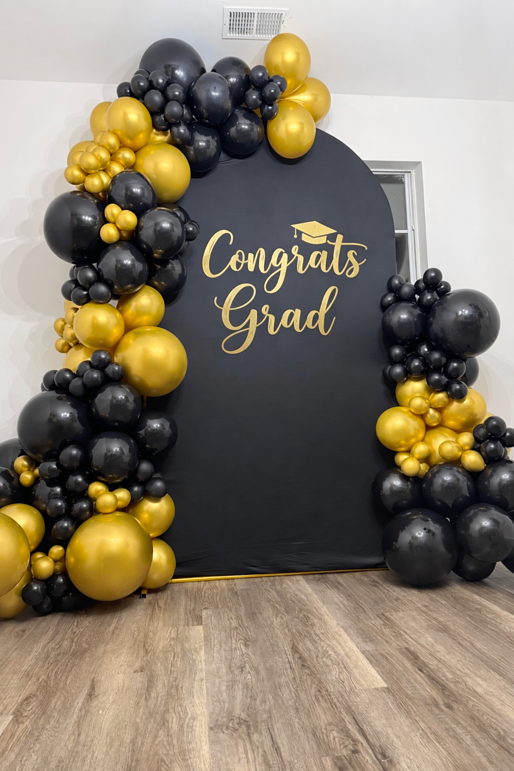 Congrats Grad black and gold balloon arch backdrop
